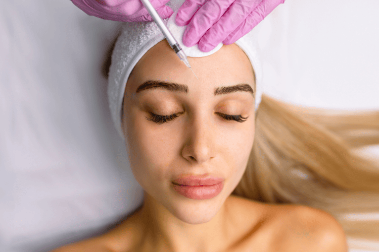 Woman receiving Botox treatment to maintain smooth, youthful skin at Elite Medical Spa.